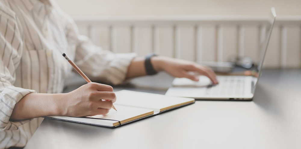 photo-of-person-writing-on-notebook-3758898
